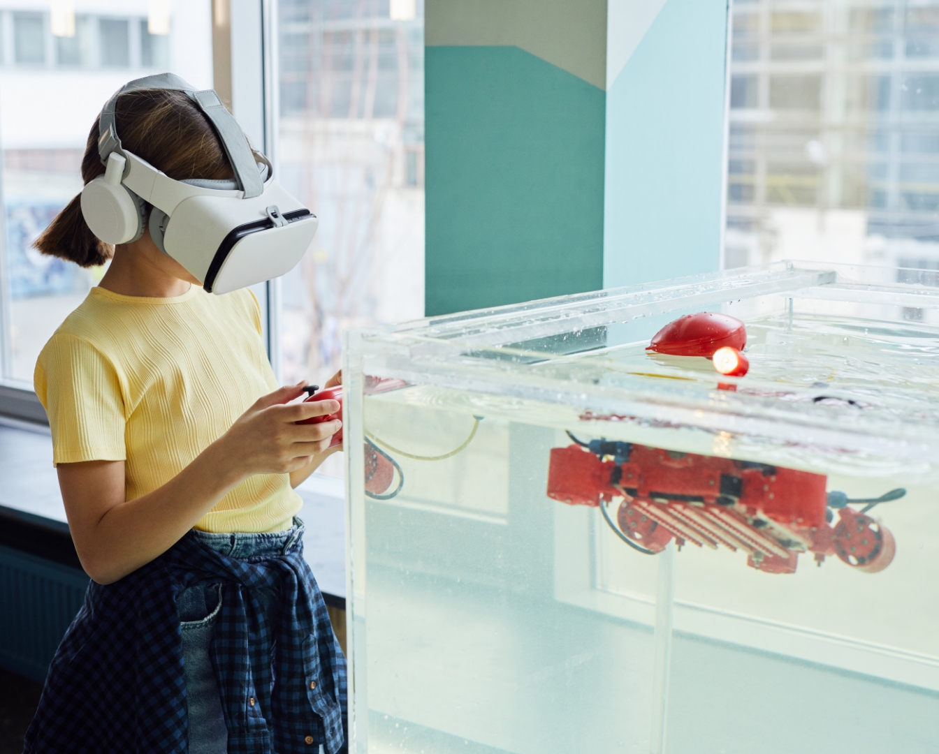 Person with mixed reality goggles controlling a robot