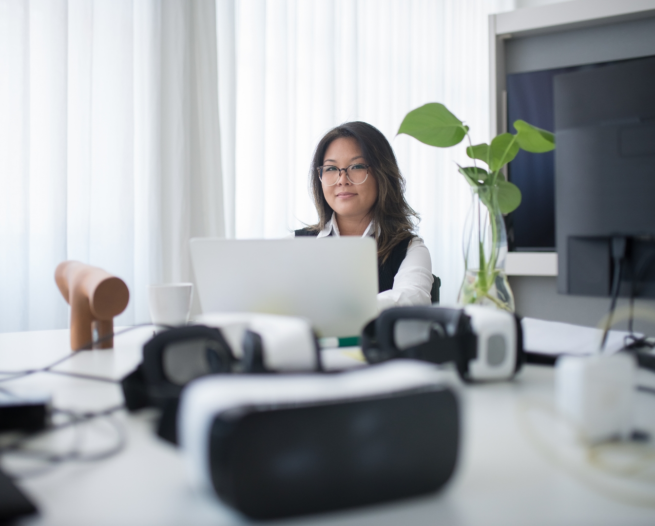 Woman working with Virtual Reality goggles placed on a table